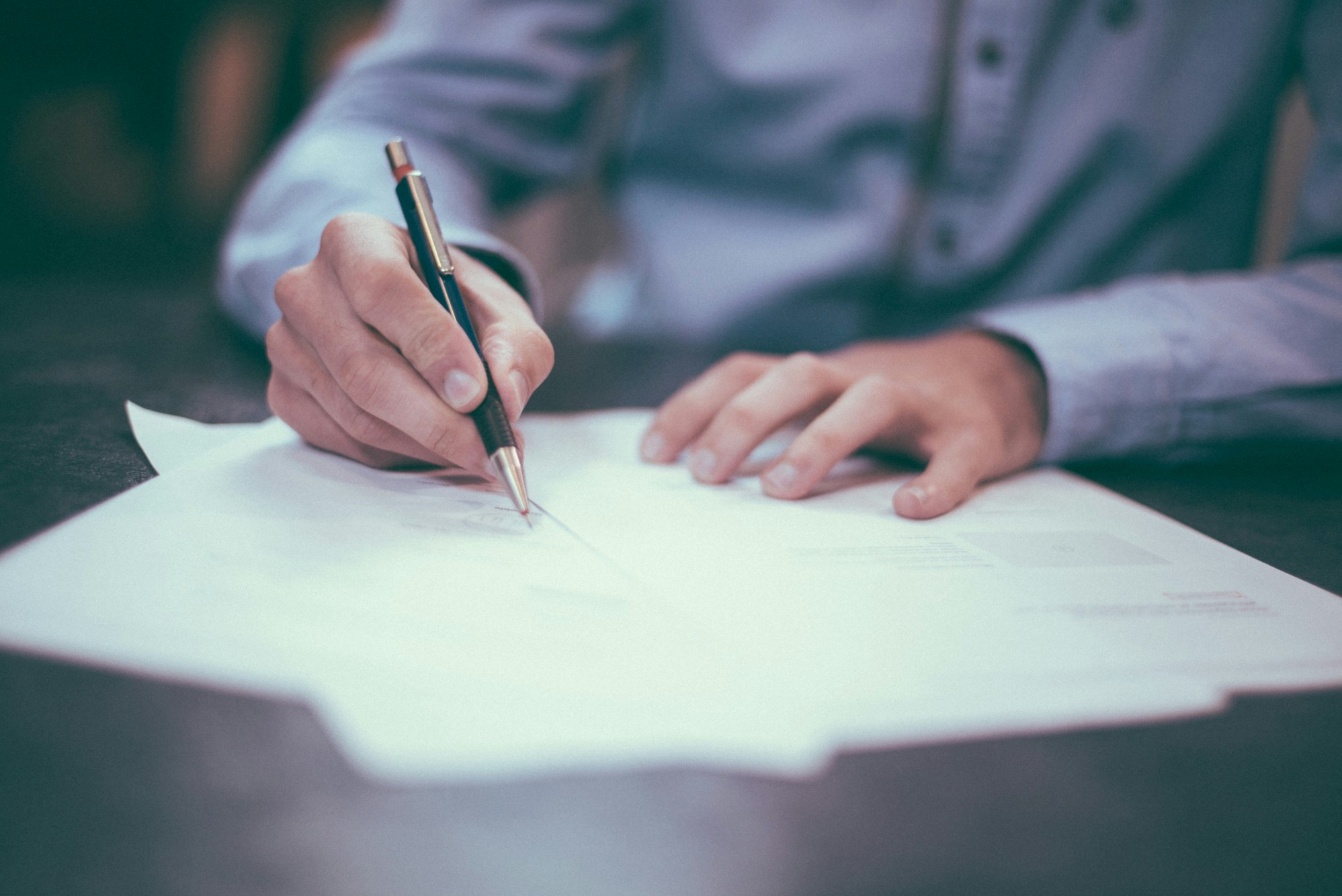 Person signing a page